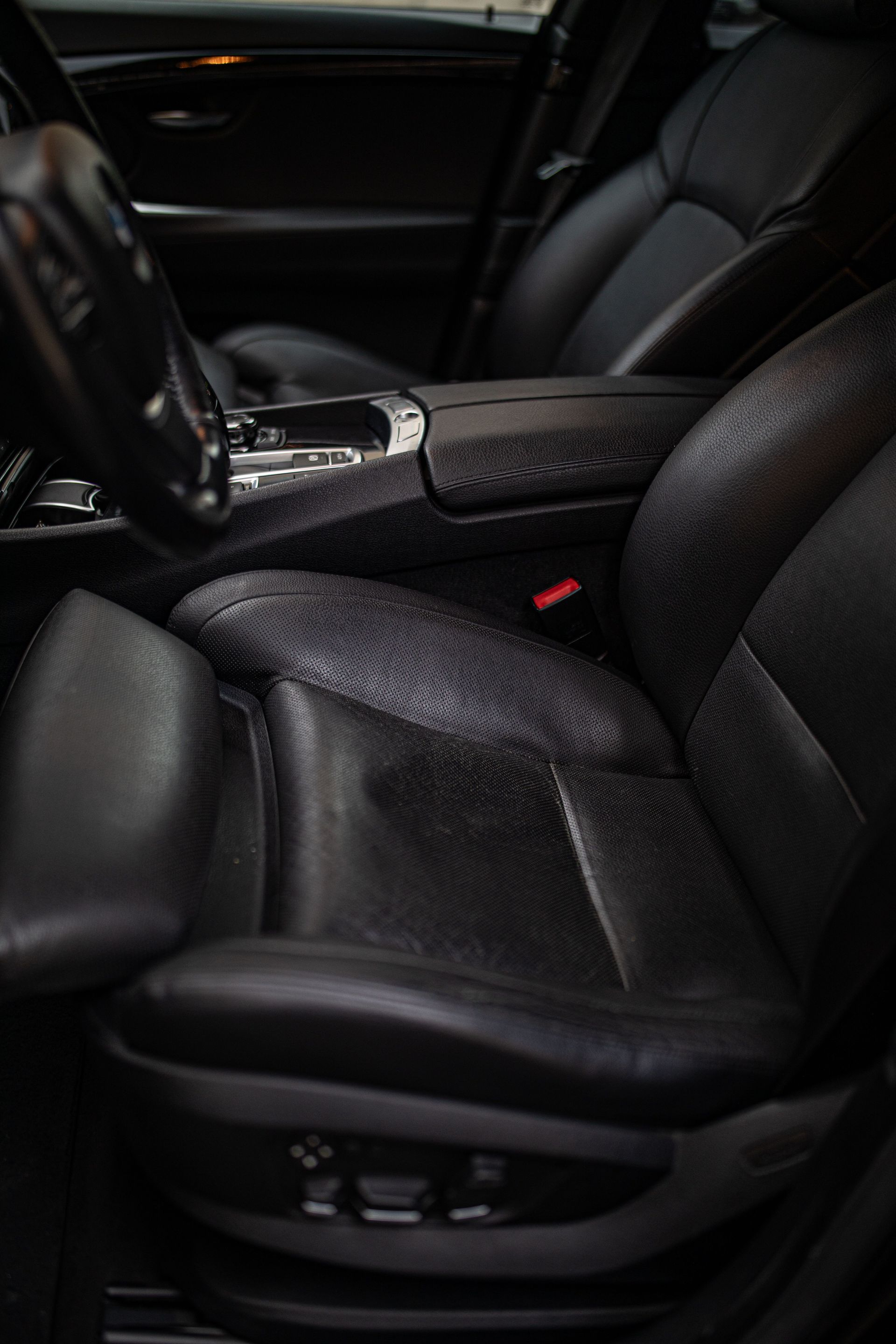 Close-up of a modern car interior featuring luxurious black leather seats and sleek design.